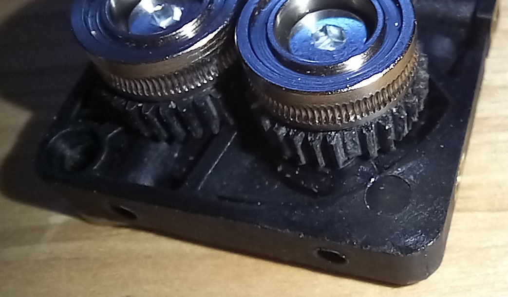 A tooth is missing and another is shaved off this K1 extruder.